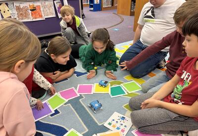 Here is a photo of students working in a group on a coding project
