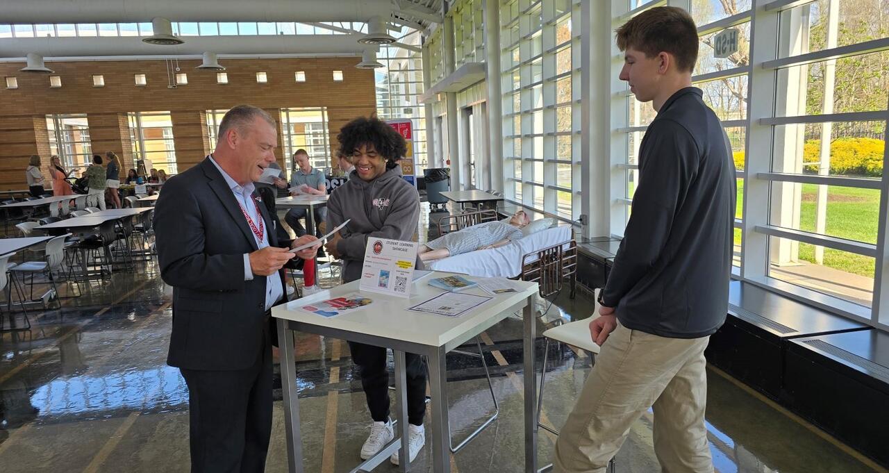 Students speaking with the superintendent