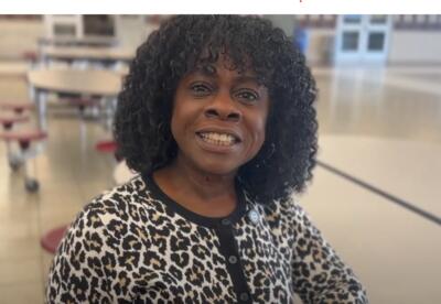 Lady smiling in cafeteria