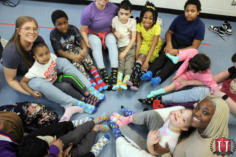 Top down view of students in circle with socks