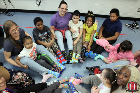 Top down photo of students in circle with socks