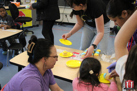 Students and staff working at table