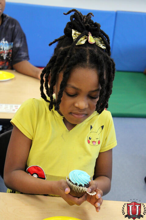 Student looking at cupcake