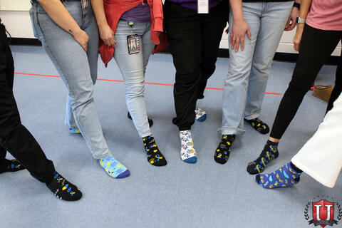 Staff shows off their decorative socks