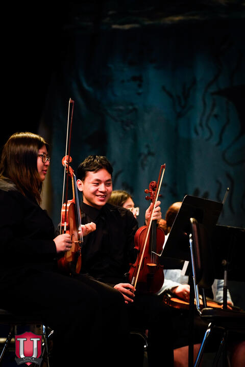 Students smiling waiting to play next song