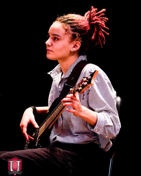 Student playing the guitar