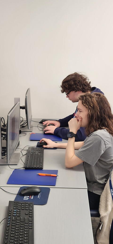 Student pondering while working