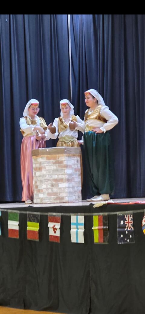 Students performing churning butter