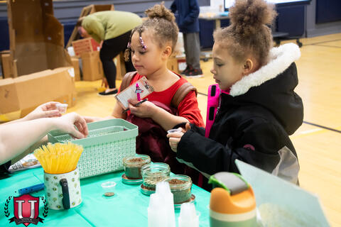 Students interacting with supplies