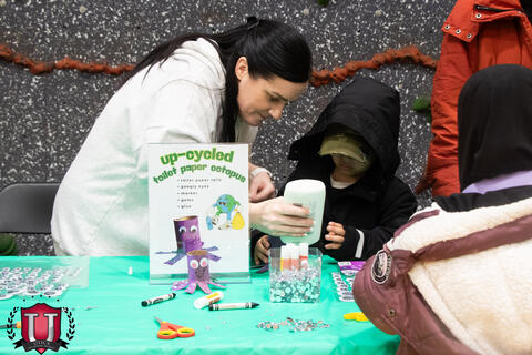 Staff helping a student glue