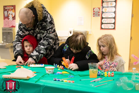 Parent helping students doing a project