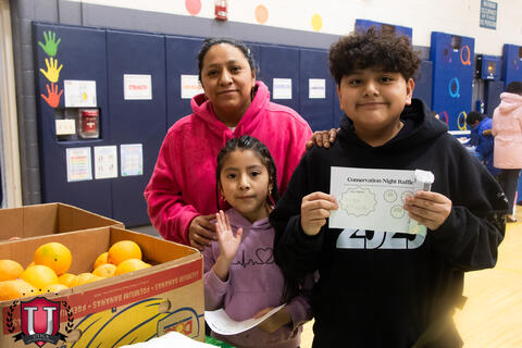 Student posing with award
