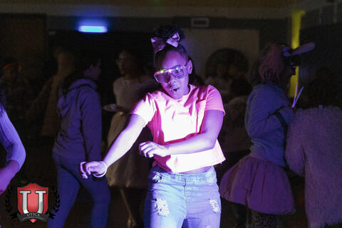 Student dancing with neon glasses