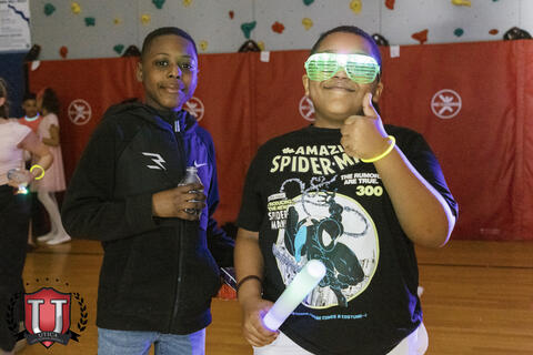 Students giving a thumbs up with his neon glasses