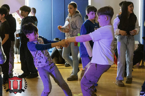 Two students swinging themselves around with their arms