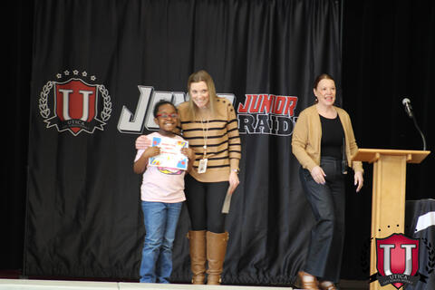 Student and teacher pose together proud