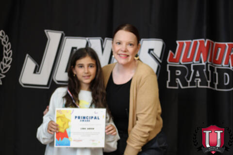 Teacher and student pose merrily