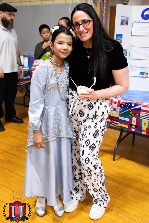 Staff and student pose togeher proudly