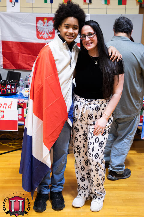 Staff posing with their flags supporting their culture