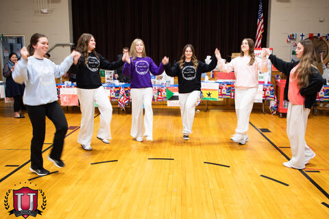 Students dancing while holding hands
