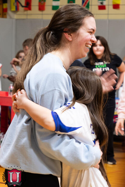 Student tightly hugging staff 