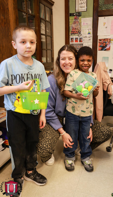 Staff and students posing with eggs