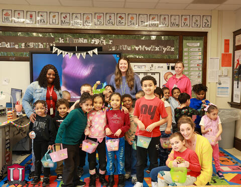 Group photo of class posing with eggs