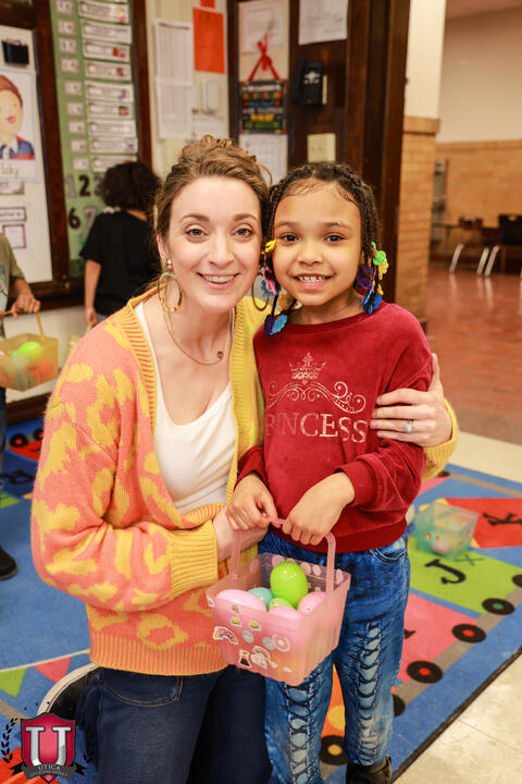 Student posing with a staff member 