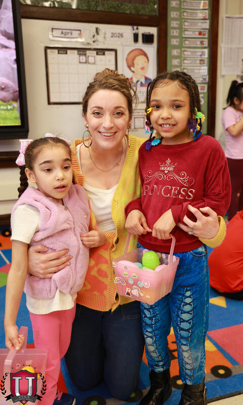 Staff posing with students holding Easter baskets