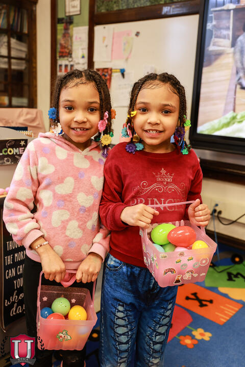 Two students posing with eggs