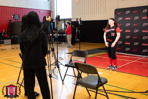 Student photographing a Student athlete