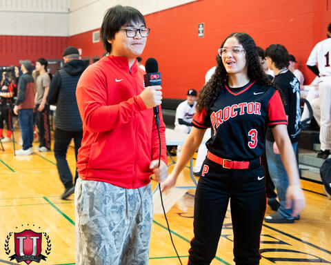 A student interviewing another student athlete