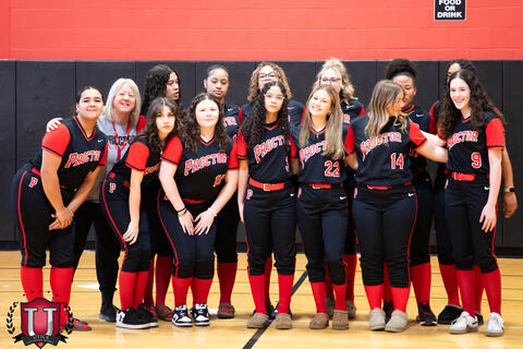 Softball team getting ready to pose together