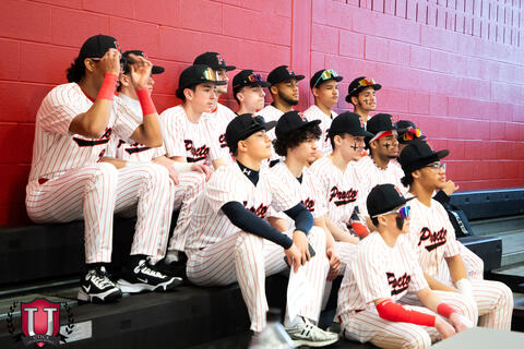 Baseball team preparing for their photo on the bleachers