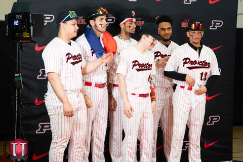 Baseball team prepares to take a photo together at stand