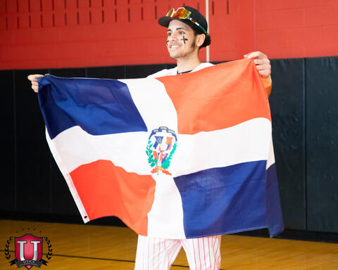 Student posing with his countries flag