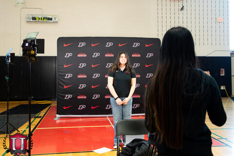 A behind the scenes shot of a student having their photo taken