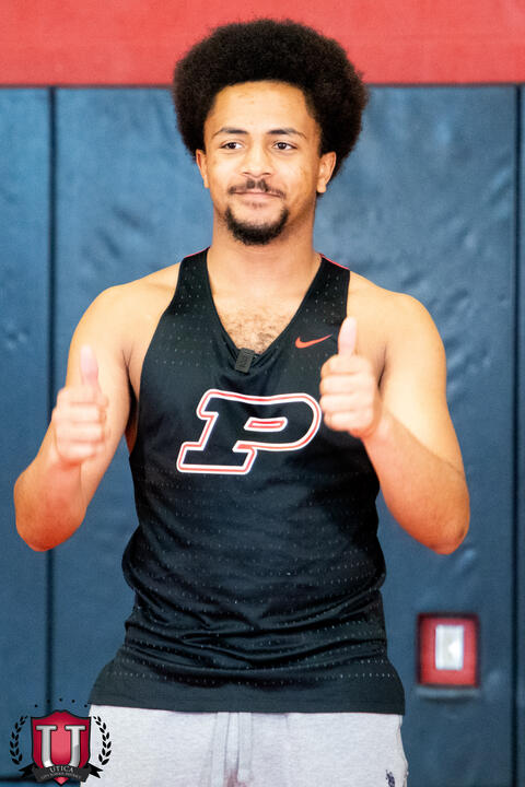 Track athlete posing with their thumbs up