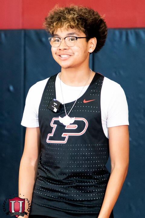 Track athlete posing with a large smile