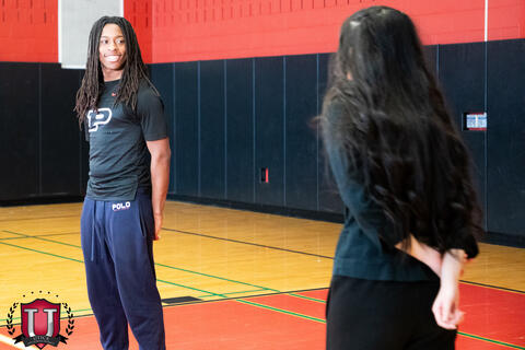 Track student being told how to pose on the set