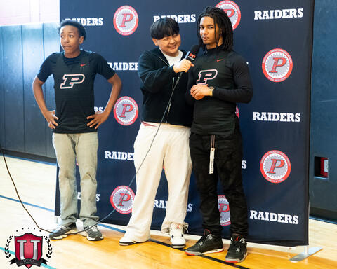 two athletes posing on the set while being interviewed