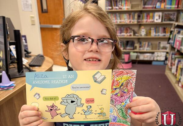 Student Holding book proudly