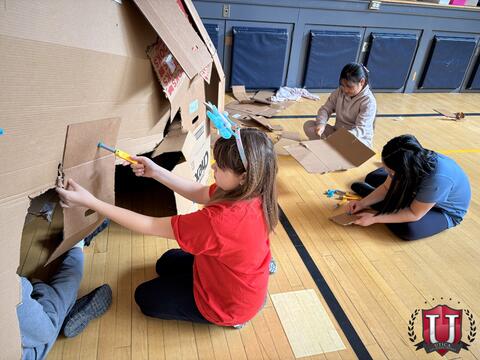 Student using a screwdriver on their box