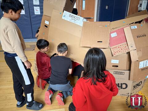 Students holding up their box