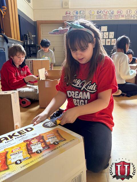 Student smiling while working on their box