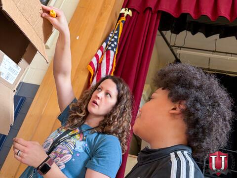 Staff showing student how to work with their box