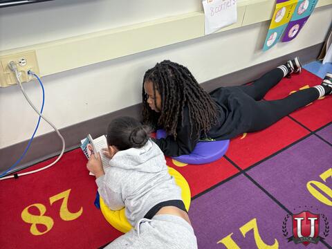 Students laying down on carpet