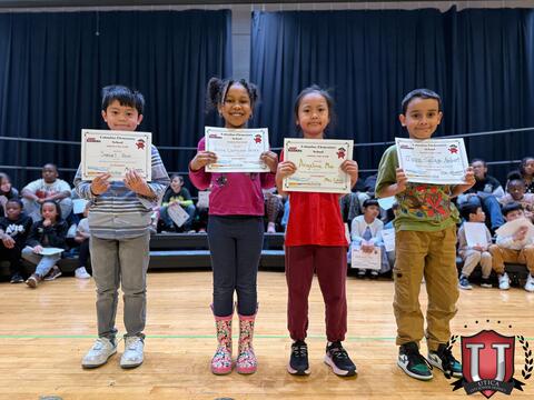 Students smiling on stage