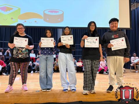 Students looking happy to be holding award