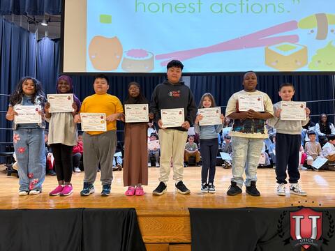 Large group of students holding awards